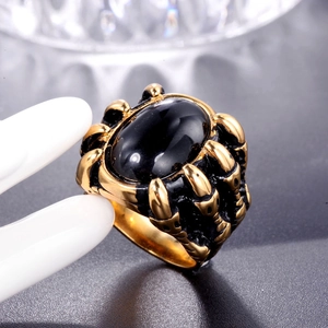 Punk style men's gold claw ring featuring a large oval black gemstone and vintage finish
