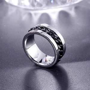 Polished titanium steel ring with black chain inlay on grey textured surface
