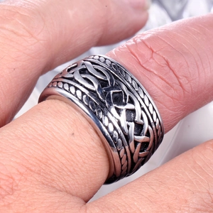 Gros plan sur une bague large punk vintage avec motifs celtiques et bords perlés