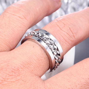Close-up of a silver titanium steel spinning Cuban chain ring for punk hip-hop jewelry style