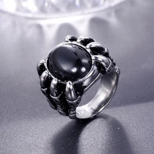Detailed view of vintage dragon claw ring with large oval black onyx stone setting