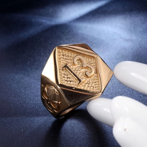 Close-up of golden number 13 ring with detailed skull carving on the side
