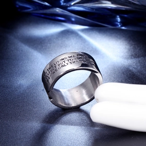 Close-up of stainless steel skull ring engraved with inspirational quote for men
