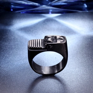 Detail view of vintage industrial lighter shaped ring with intricate steel wheel mechanism