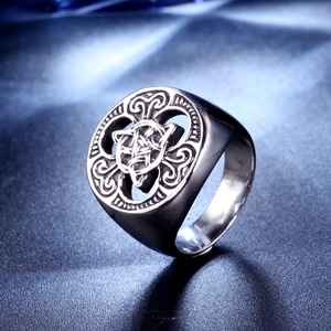 Vintage stainless steel Viking ring with Celtic knot pattern on a textured background