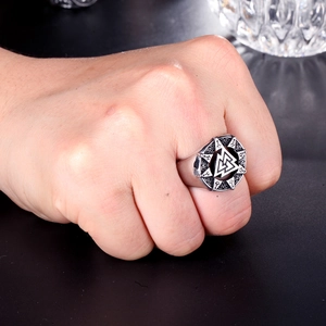Close-up of men's stainless steel Valknut ring with vintage silver finish and engravings