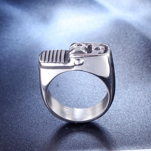 Macro close-up of retro lighter-shaped stainless steel ring with detailed metal texture