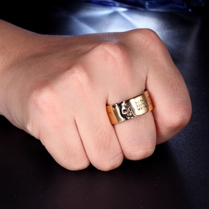 Detailed close-up of a men's gothic skull ring in gold finish with vintage engraving
