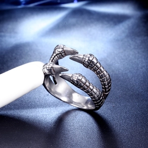 Macro detail of gothic stainless steel dragon claw ring with realistic scale textures
