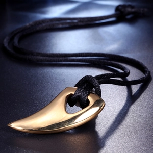 Polished gold tusk pendant necklace on black woven cord with sharp metallic finish