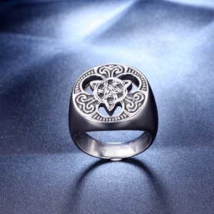 Macro shot of silver Viking steel ring featuring intricate Celtic knot patterns