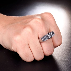 Close-up of vintage punk lighter-shaped ring in silver steel on man's finger