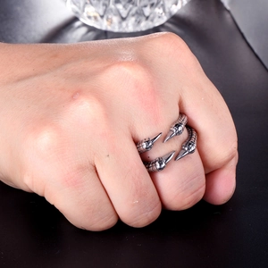 Macro shot of stainless steel dragon claw ring with vintage textured scale details