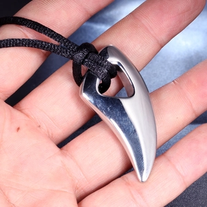 Polished stainless steel horn pendant with hollow triangular detail on a black cord