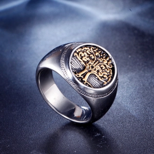Vintage stainless steel Tree of Life signet ring with gold accent on a matte silver band