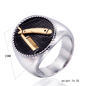 Detailed macro view of vintage stainless steel signet ring with gold razor emblem