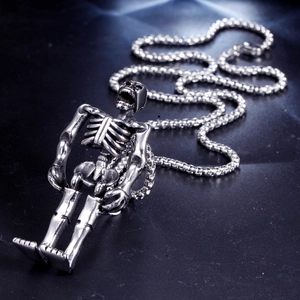 Detailed view of punk skeleton skull pendant on box chain with a vintage silver finish