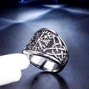 Macro shot of Viking Vegvisir compass and Celtic knots on vintage steel ring