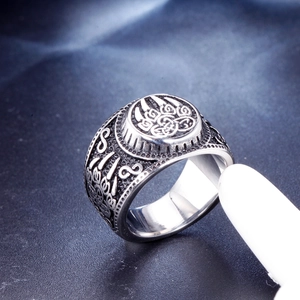 Vintage stainless steel Viking ring featuring a central bear paw and Celtic knot patterns