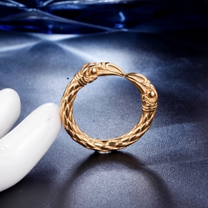 Detailed close-up of golden eagle motif ring with intricate scale texture and punk style