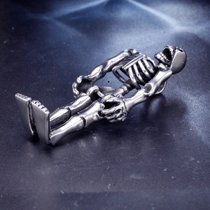 Macro view of detailed vintage silver skeleton pendant with gothic anatomical textures