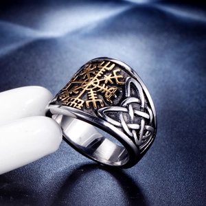 Close-up of Viking Vegvisir ring with golden rune pattern and silver Celtic knots