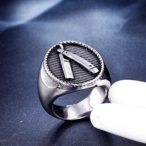 Macro detail of men's stainless steel ring with embossed razor blade and punk design