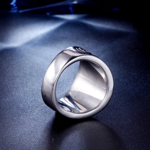 Macro detail of polished stainless steel Viking ring with engraved circular G logo