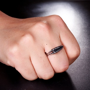 Macro detail of retro punk claw ring showing realistic dragon scale texture and dark finish