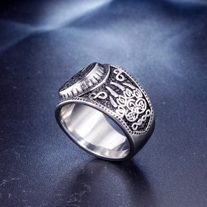 Vintage stainless steel Viking ring featuring intricate Celtic knot and bear claw carvings