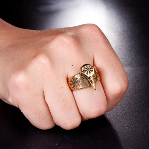 Macro view of vintage gold crow skull ring with Viking compass engraving on side