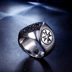 Macro detail of men's vintage stainless steel knight ring with maltese cross relief