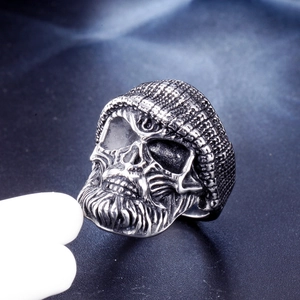 Macro shot of stainless steel biker ring featuring skull with beanie hat and beard