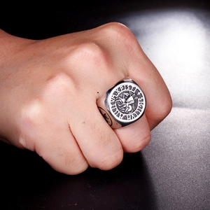 Macro view of men's vintage silver Knight Templar seal ring with cross relief
