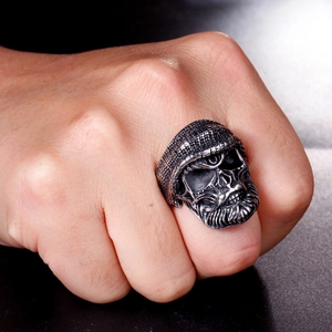 Detailed close-up of a vintage stainless steel skull ring with hat and beard details