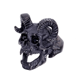 Macro detail of punk ram skull ring featuring devil horns and goth stainless steel textures