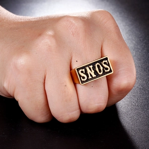 Detail of gold men's signet ring with embossed SNOS text on rectangular face