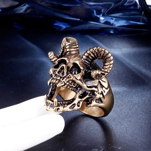 Macro shot of punk ram skull ring in antique gold finish with black rhinestone eyes