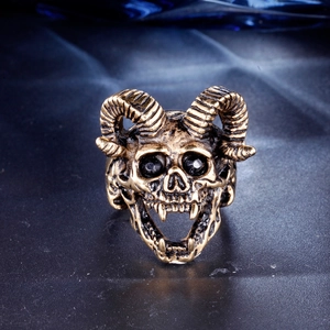 Macro view of gothic punk ram skull ring with black gemstones and vintage bronze finish