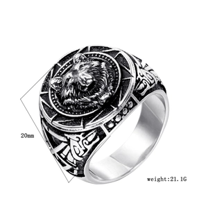 Detailed macro shot of vintage wolf head engraving on silver steel ring for men
