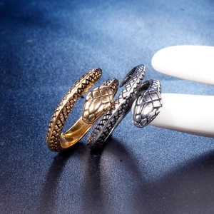 Minimalist snake-shaped stainless steel rings with detailed scale texture in gold and silver
