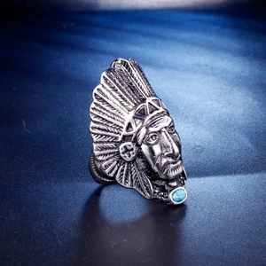 Detail of vintage native American chief steel ring with blue stone and feather headpiece