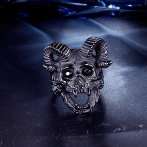 Macro detail of gothic ram head skull ring with black gems and vintage silver finish