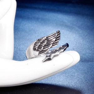 Macro shot of vintage silver angel wing ring showing detailed feather texture