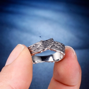 Detailed view of silver feather wing ring showing fine vintage texture and gothic style