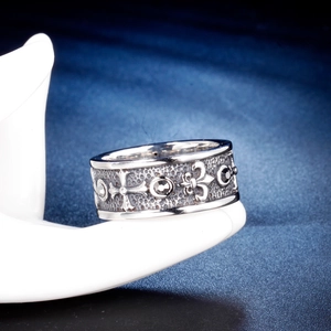 Vintage gothic titanium steel cross ring with iris patterns shown on a hand model