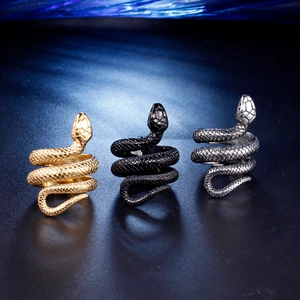 Three-color coiled snake rings in gold, black, and silver with realistic scale texture