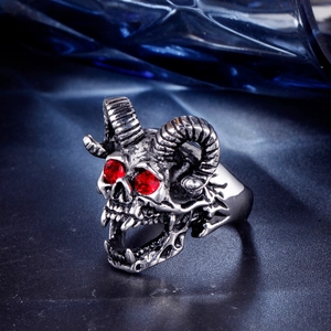 Macro shot of punk ram skull ring with vintage oxidized finish and red zircon eyes