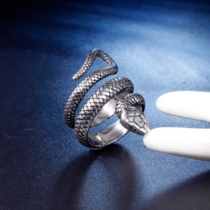 Detailed macro view of vintage stainless steel ring with intricate snake scale carvings