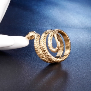 Macro shot of gold snake ring featuring detailed scales on a multi-layered wrap band
